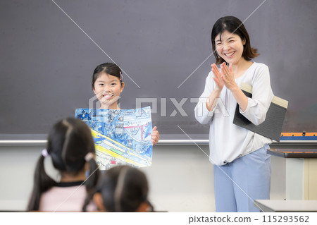孩子和老師在學校展示他們的繪畫和工藝品。 孩子和老師在學校展示他們的繪畫和工藝品。 115293562