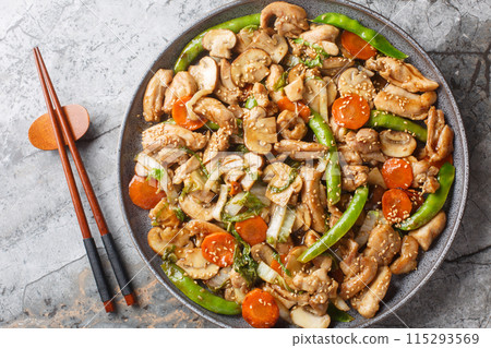 Moo Goo Gai Pan or Mah Gu Gai Pan is the Chinese dish chicken with mushroom in savory sauce closeup on the plate. Horizontal top view Moo Goo Gai Pan or Mah Gu Gai Pan is the Chinese dish chicken with mushroom in savory sauce closeup on the plate. Horizontal top view 115293569