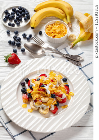 fresh berries, banana with corn flakes and yogurt 115293818
