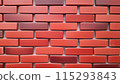 充滿活力、色彩繽紛的磚牆圖案，具有各種深淺的紅色和橙色。 115293843
