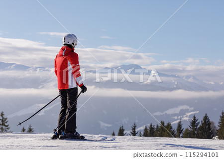 man and woman skiing and snowboarding in the mountains 115294101