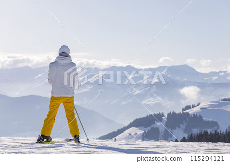 man and woman skiing and snowboarding in the mountains 115294121