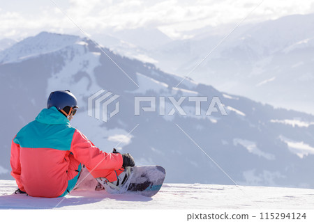 man and woman skiing and snowboarding in the mountains 115294124