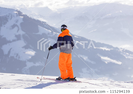 man and woman skiing and snowboarding in the mountains 115294139