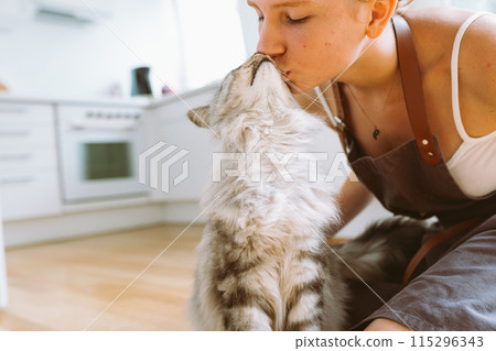 Portrait red-haired curly young woman with beloved fluffy domestic cat 115296343