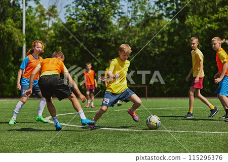 Teen boys in vibrant sports attire maneuver soccer ball with precision and speed, emphasizing teamwork and strategy. Outdoor game Teen boys in vibrant sports attire maneuver soccer ball with precision and speed, emphasizing teamwork and strategy. Outdoor game 115296376