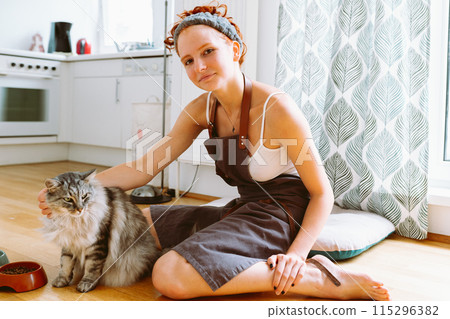 Portrait red-haired curly young woman with beloved fluffy domestic cat Portrait red-haired curly young woman with beloved fluffy domestic cat 115296382