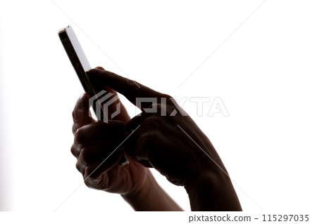 Senior woman silhouette smartphone hand 115297035