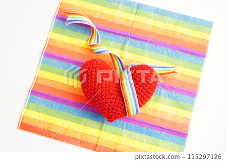 Red heart with rainbow color ribbon flag isolated on white background with clipping path, LGBT symbol. 115297126