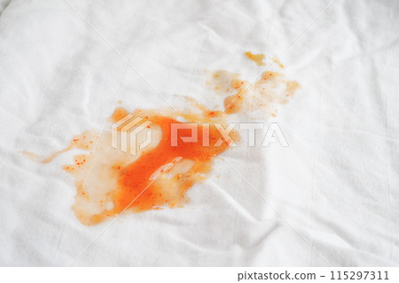 Dirty tomato sauce stain or ketchup on cloth to wash with washing powder, cleaning housework concept. 115297311