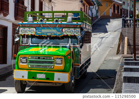 Traditional Colombian colorful rural bus, called chiva, at the beautiful streets of the heritage town of Aguadas in Colombia. Traditional Colombian colorful rural bus, called chiva, at the beautiful streets of the heritage town of Aguadas in Colombia. 115298500