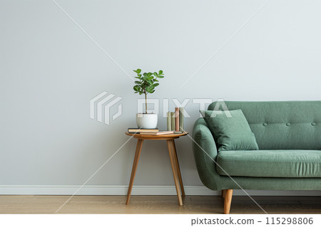 Minimalist living room with a clean and cozy aesthetic, featuring a green fabric sofa 115298806