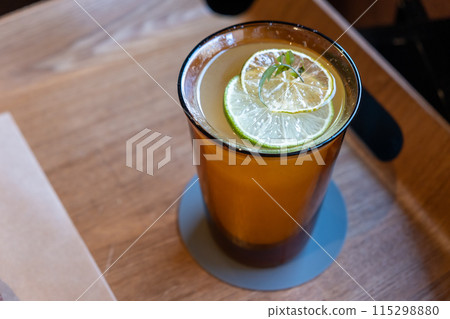 A glass of iced lemon tea on the wooden tray 115298880