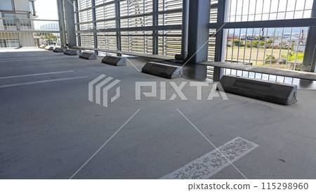 Parking lot scene (multi-storey car park with puddles) 115298960
