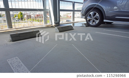 Parking lot scene (multi-storey car park with puddles) 115298966
