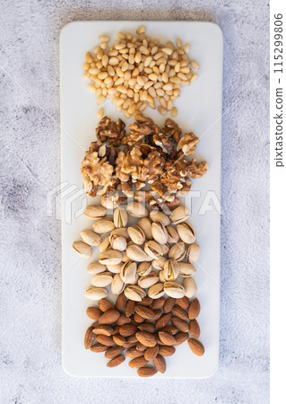 Mix of different nuts on a white plate. Mix of different nuts on a white plate. 115299806