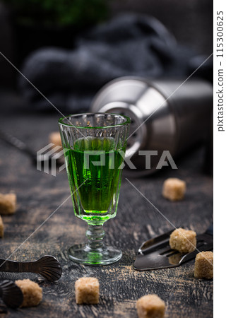 Glass of absinthe with cane sugar 115300625