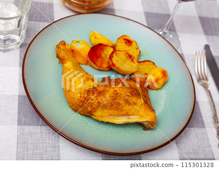 Portion of roasted chicken leg with potatoes Portion of roasted chicken leg with potatoes 115301328