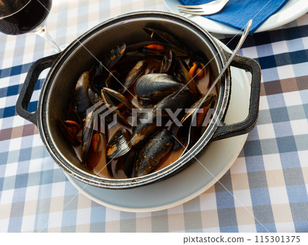 Moules a la marinera braised in sauce in fry pan Moules a la marinera braised in sauce in fry pan 115301375