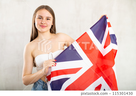 Young woman with UK flag posing in studio Young woman with UK flag posing in studio 115301430