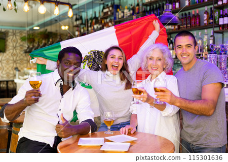 Emotional multiracial man and woman spots supporters with flag of Mexico happy about victory in championship 115301636