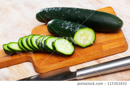 Many ripe cucumbers on wooden surface Many ripe cucumbers on wooden surface 115301652