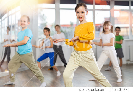 Girl learn to dance hip hop dances, doing movement with unrecognizable teacher. Girl learn to dance hip hop dances, doing movement with unrecognizable teacher. 115301781