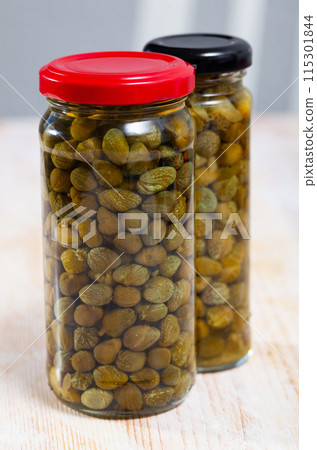 Glass jar with pickled capers 115301844