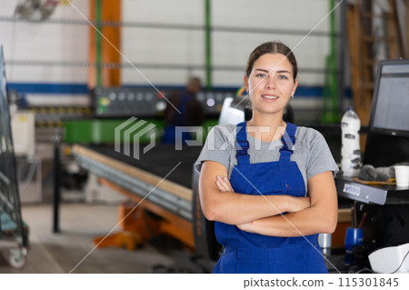 Confident smiling young female worker in glass workshop 115301845
