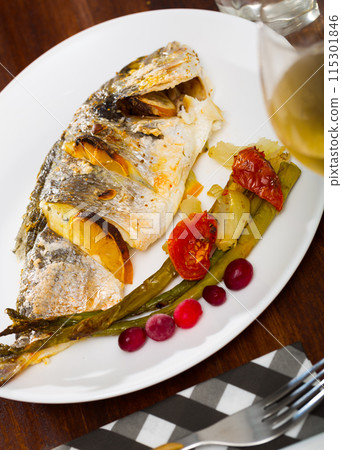 Roasted dorada with baked vegetables and cranberries Roasted dorada with baked vegetables and cranberries 115301846