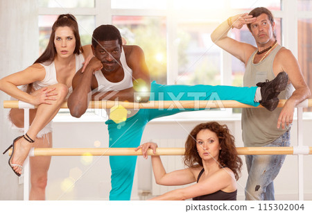 Group of men and women posing at barre Group of men and women posing at barre 115302004