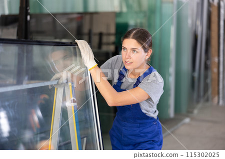 Female foreman inspecting plate glass cut to size Female foreman inspecting plate glass cut to size 115302025