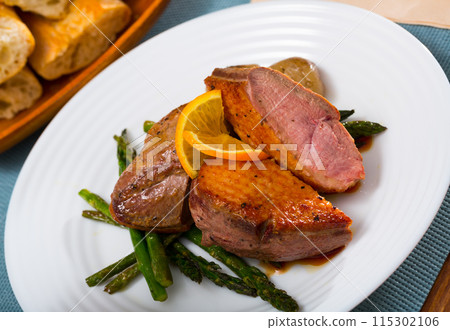 Roasted duck breast with asparagus closeup Roasted duck breast with asparagus closeup 115302106