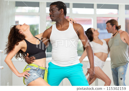 Man and woman practicing sensual bachata in dance class 115302159