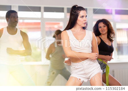 Girl in heels conducts lessons and teaches strip plasticity to visitors of dance 115302184