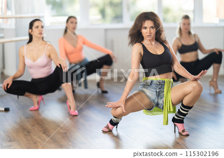 Group of women in high heels dances on floor 115302196