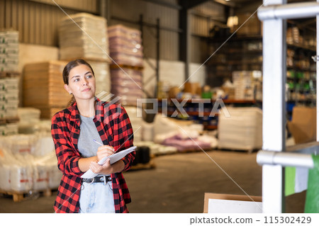 Young woman inspecting storehouse Young woman inspecting storehouse 115302429