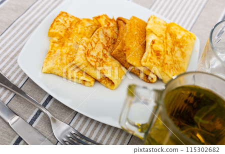 Delectable pancakes, featuring sweet fruit preserve filling 115302682