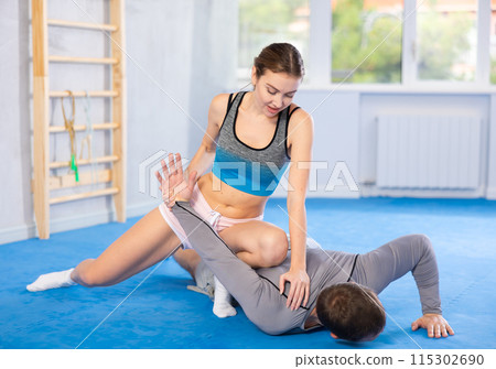 Adult man and young woman training self-defense techniques Adult man and young woman training self-defense techniques 115302690