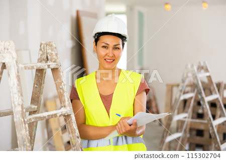 Woman construction worker with project documentation Woman construction worker with project documentation 115302704