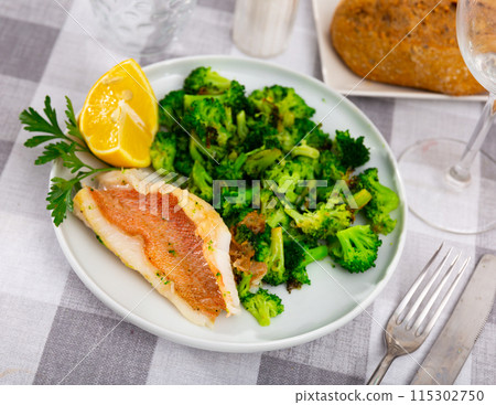 Appetising roasted rockfish fillet with seared broccoli Appetising roasted rockfish fillet with seared broccoli 115302750