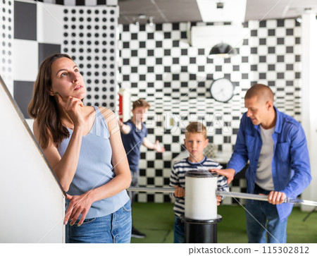 Thoughtful young woman solving conundrums in quest room 115302812