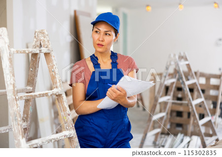 Female engineer matching check list during repair works 115302835