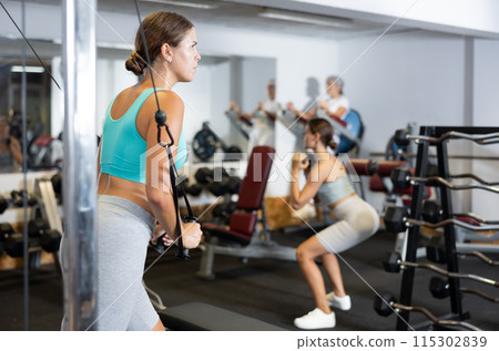 Young woman training with straps in gym Young woman training with straps in gym 115302839