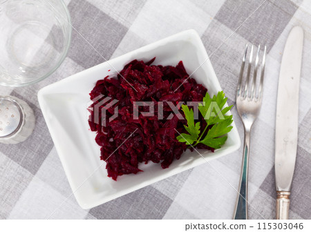 Popular russian salad, made from boiled grated beetroot, decorated with herbs 115303046