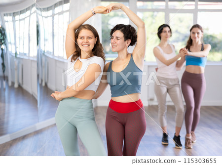 Middle-aged woman and girl are dancing vigorous pair dance in couple Middle-aged woman and girl are dancing vigorous pair dance in couple 115303655