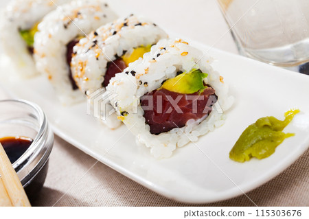 Image of tasty uramaki sushi with raw tuna fish and fresh avocado 115303676