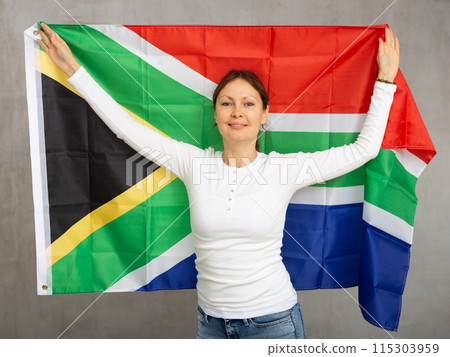 Happy smiling woman proudly displaying south african flag 115303959