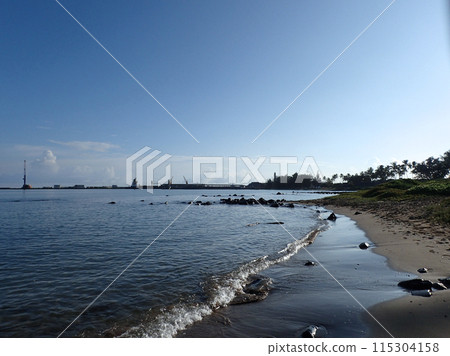 water along beach shore of Kahului Bay 115304158