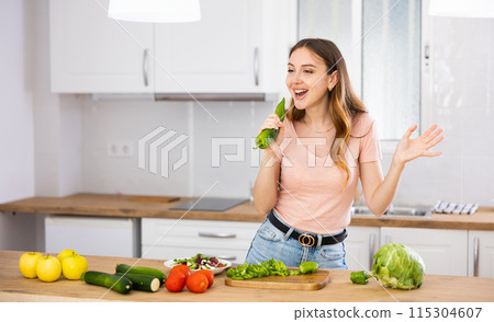 Girl have fun in kitchen singing song with bell pepper Girl have fun in kitchen singing song with bell pepper 115304607